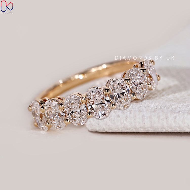 Lab grown oval diamond band with prong setting.
