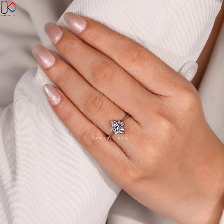 Marquise diamond ring with round side stones.
