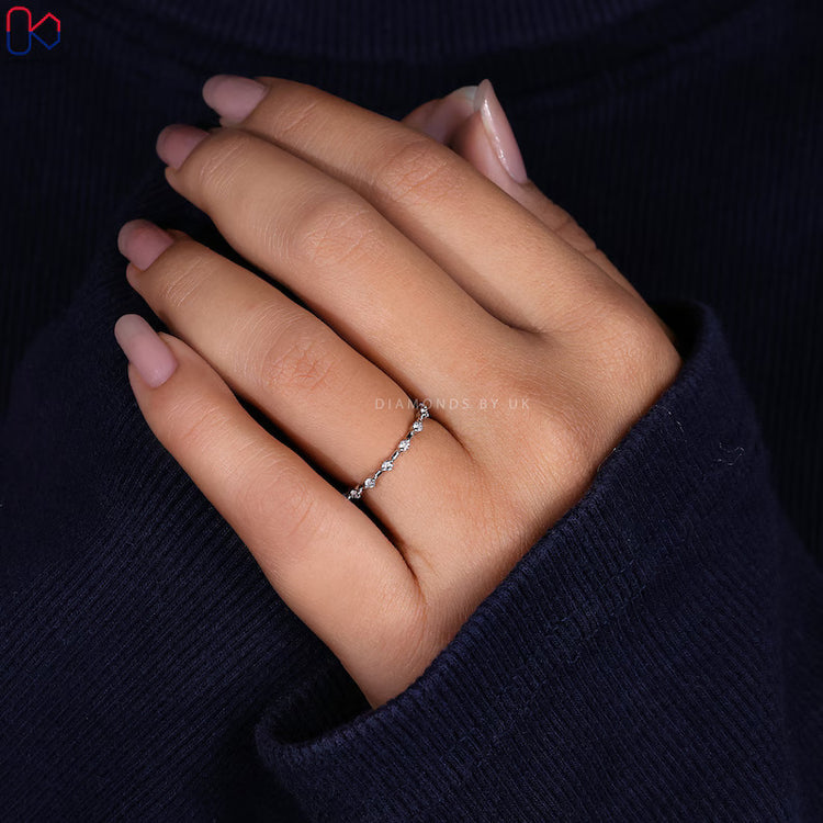 Round cut wedding band with distance pavé diamond setting.
