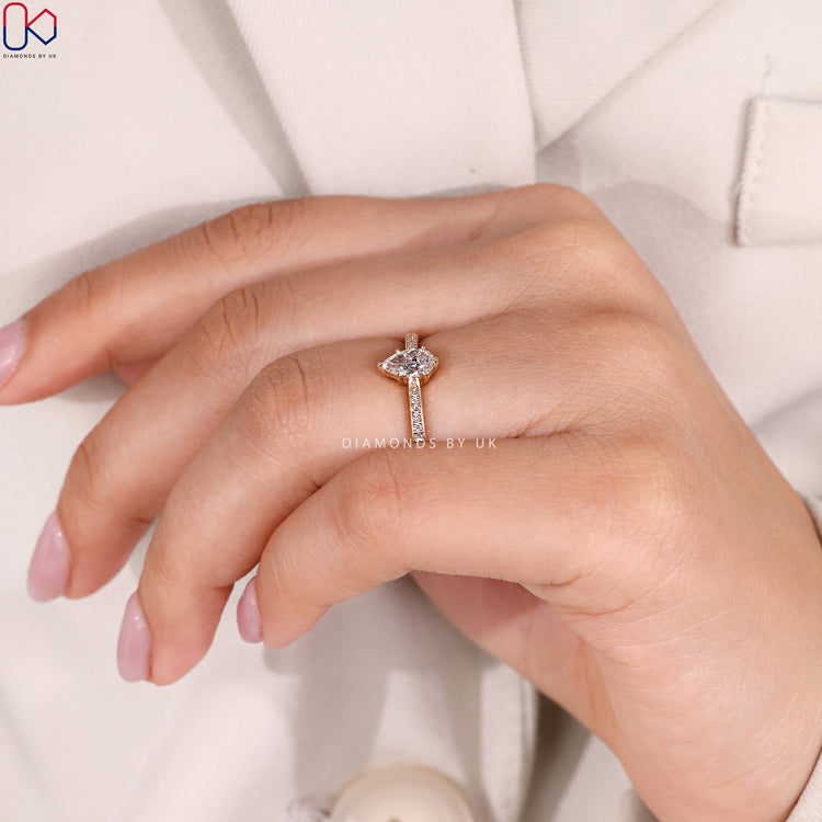 Lab grown pear cut ring with tapered pavé band.