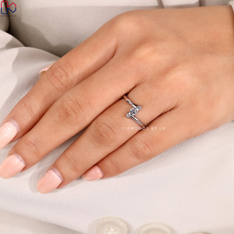 Round diamond ring with bypass and bar setting.
