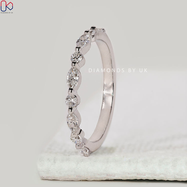 Marquise and round diamond band with shared prong setting.