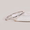 Distance pave wedding band featuring lab grown diamonds in a clean, spaced layout.
