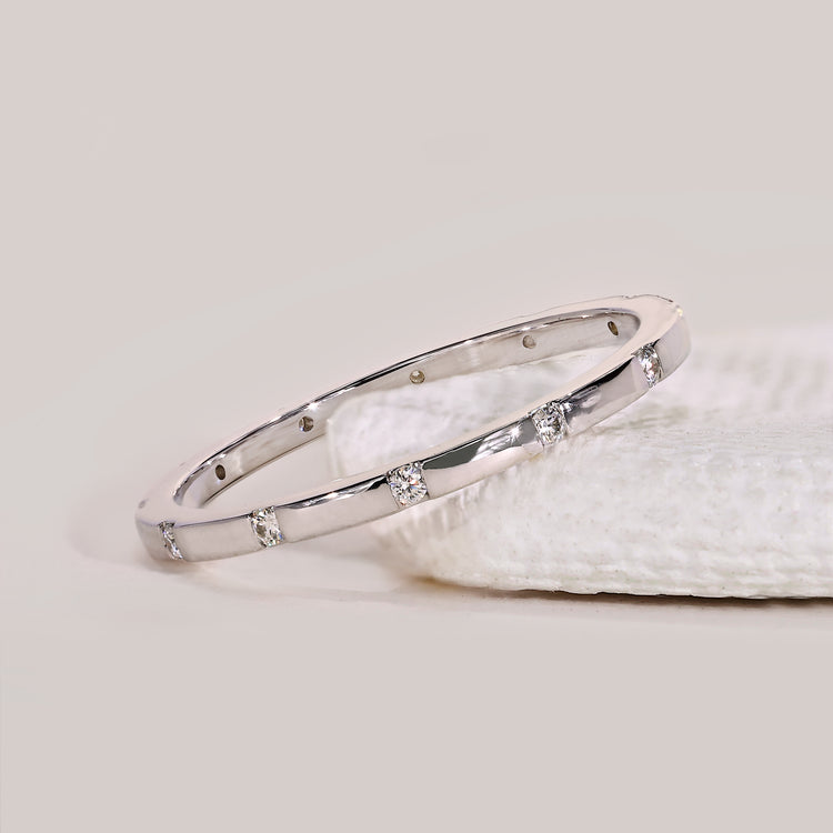 Distance pave wedding band featuring lab grown diamonds in a clean, spaced layout.
