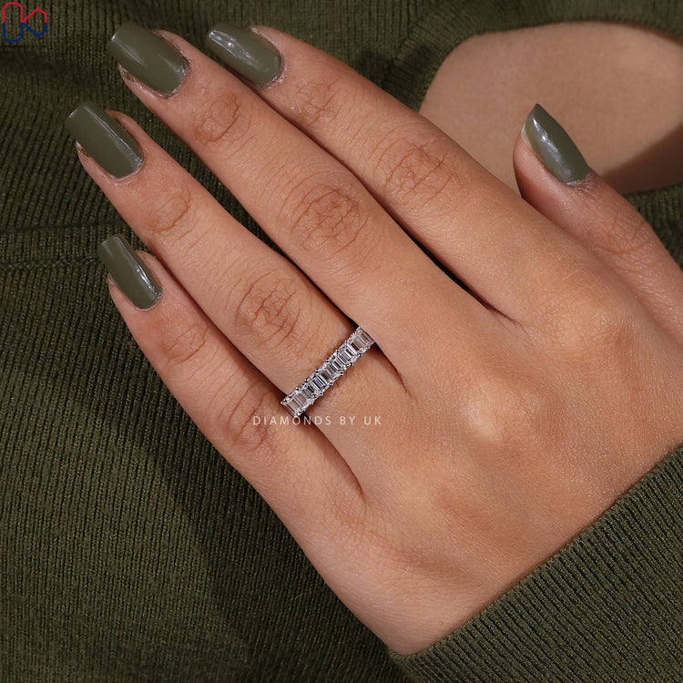 Diamondsbyuk emerald cut diamond band with prong setting.
