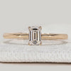 Emerald cut engagement ring with tapered shank.