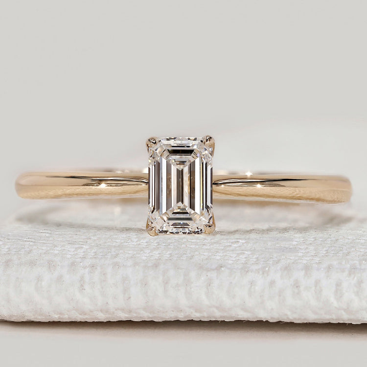 Emerald cut engagement ring with tapered shank.