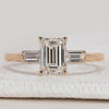 Emerald cut ring with baguette side stones design.
