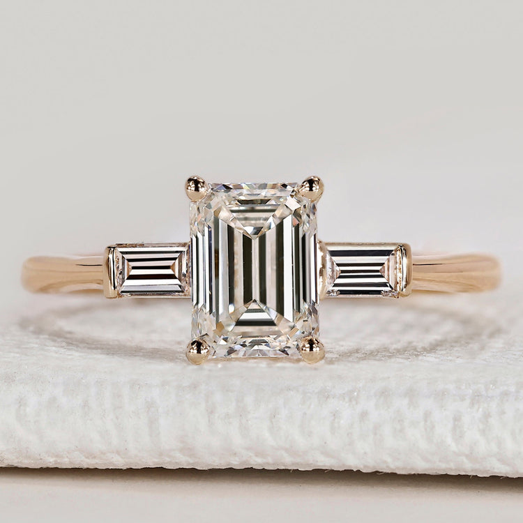 Emerald cut ring with baguette side stones design.