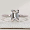 Emerald cut solitaire ring with half bezel setting.
