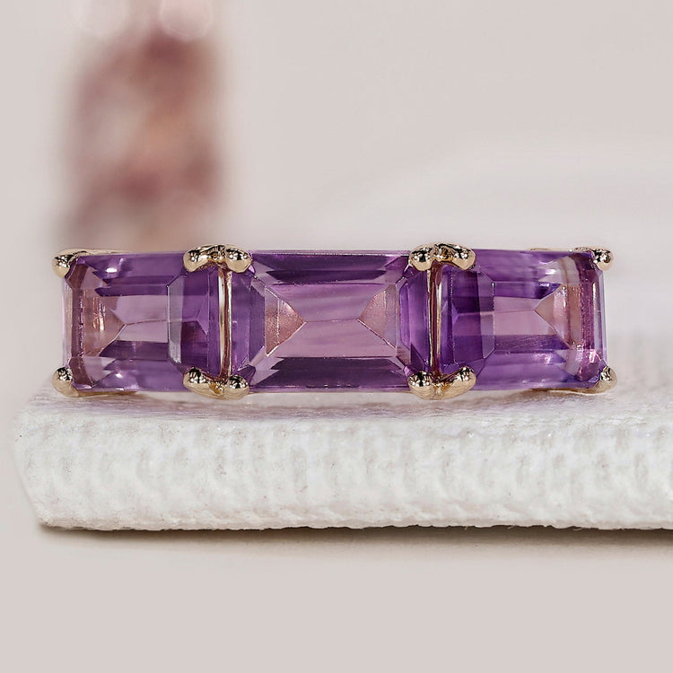 Handmade ring with emerald cut center and prong setting.