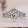 Marquise engagement ring with matching chevron diamond band.