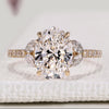 Oval diamond engagement ring with marquise side stones.