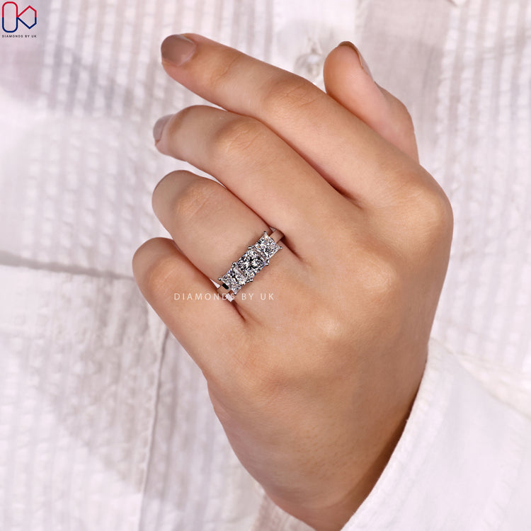 Three stone princess cut ring with prong setting.