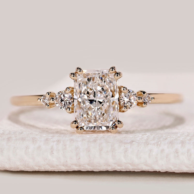 Radiant cut ring with round side stone design.