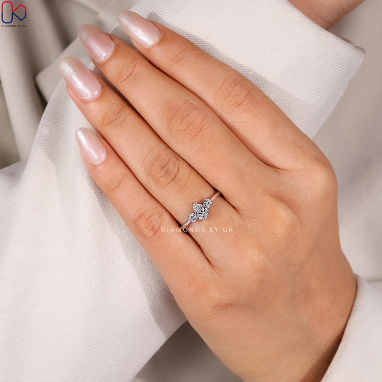 Lab grown pear diamond ring with claw prongs.