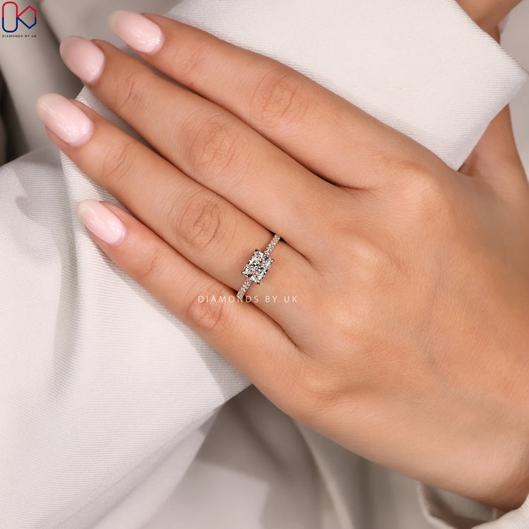Radiant cut ring with east to west diamond setting.