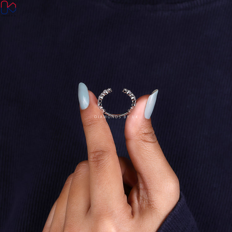 A white gold wedding band featuring a classic prong setting with lab grown diamonds.

