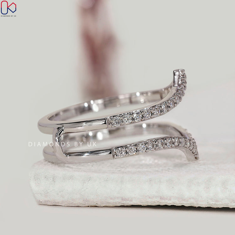 Enhancer wedding band styled with a V-shape to nest against an engagement ring.
