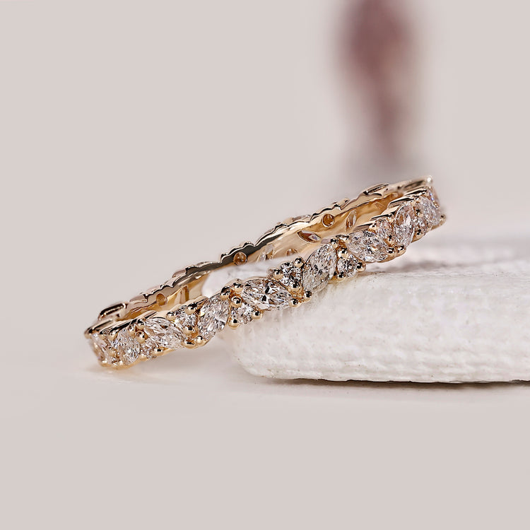 Marquise diamond full eternity wedding band crafted in yellow gold for lasting wear.
