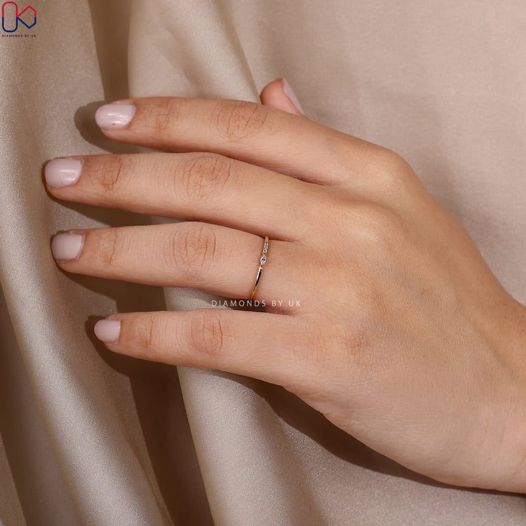 Tiny diamond wedding band crafted with precision in a four-stone layout.
