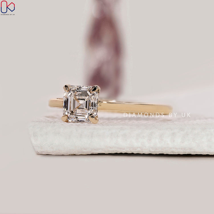 DiamondsbyUK yellow gold Asscher cut engagement ring.
