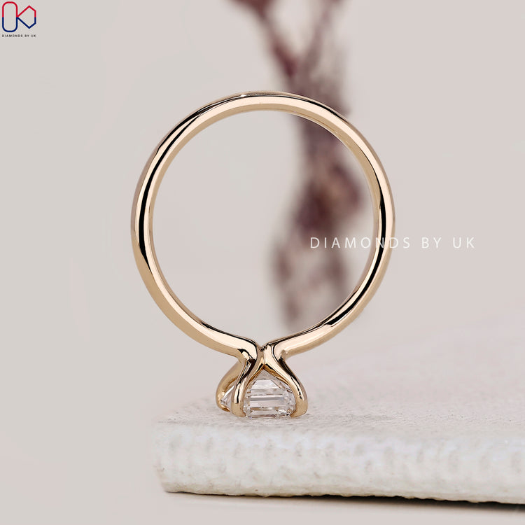 Minimalist solitaire engagement ring with Asscher diamond.
