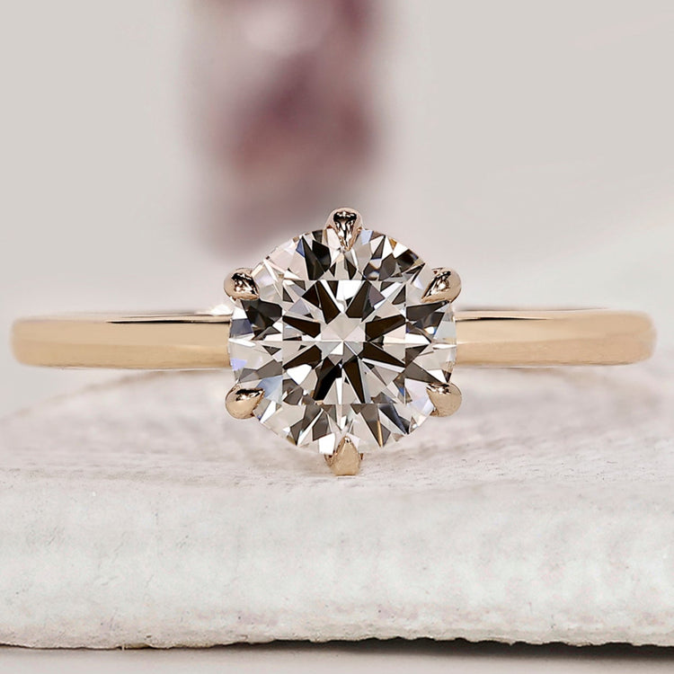 Yellow gold solitaire engagement ring with diamond engagement ring.
