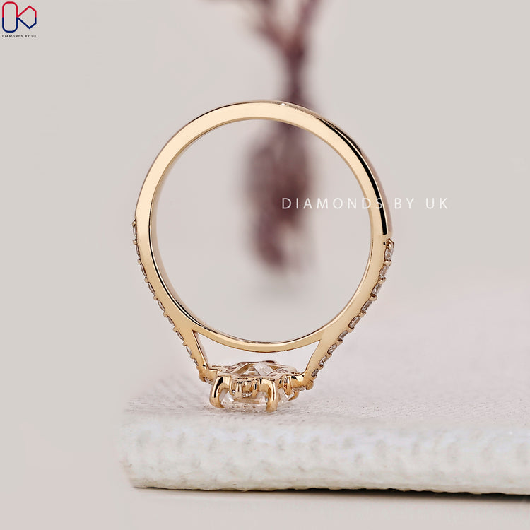 Round cut side stone with yellow gold engagement ring.
