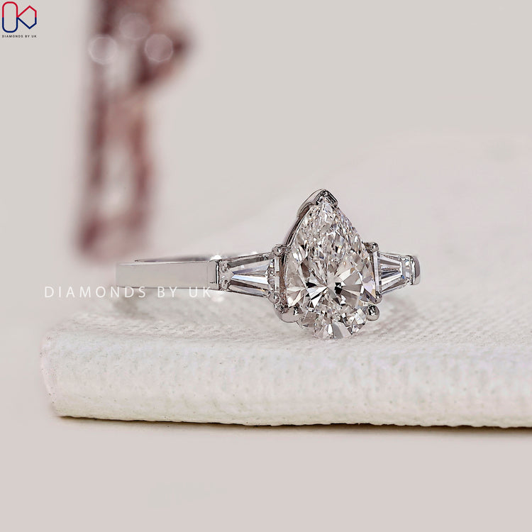 Two tapered baguette side stone ring in V prong setting.
