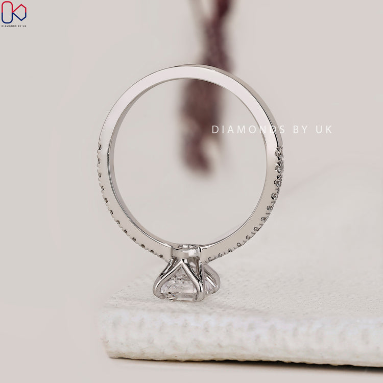 White gold ring with Asscher center and round pave sides.