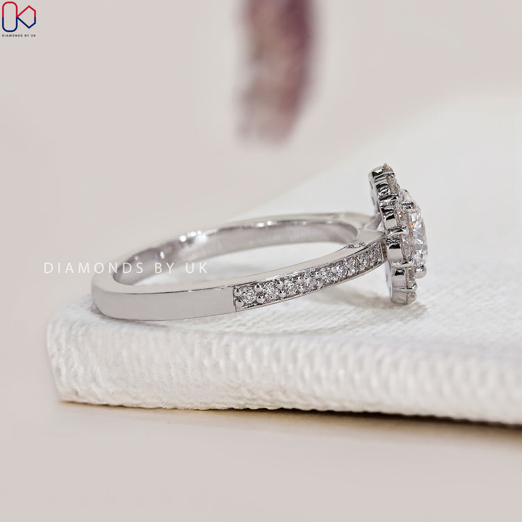 Handmade jewelry featuring a round diamond in pave setting.
