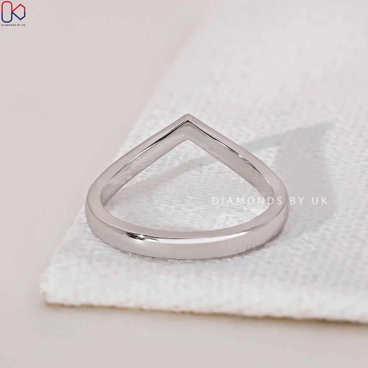 Shared prong wedding band highlighting secure settings for maximum diamond brilliance.
