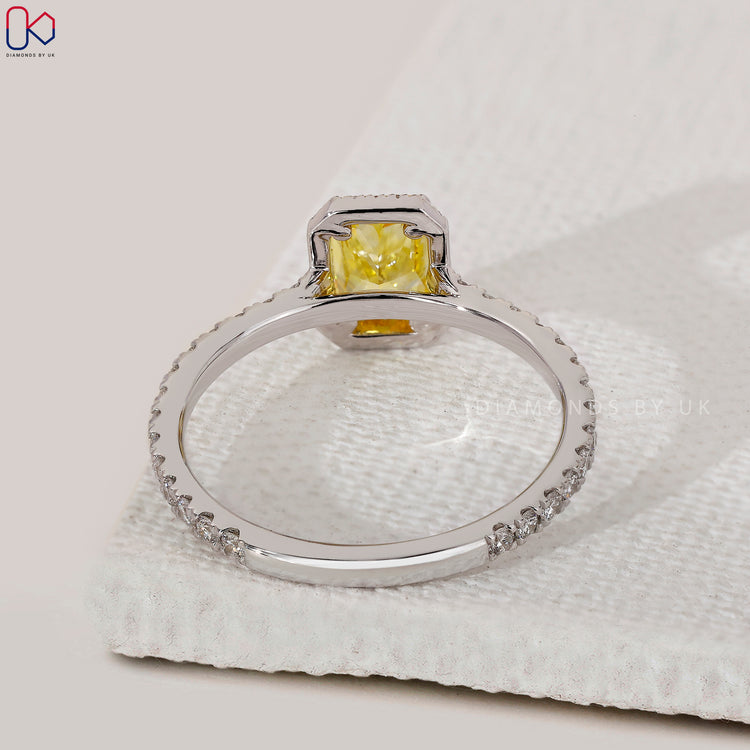 Four claw prong yellow diamond engagement ring.
