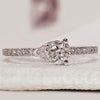 Pave diamond ring with round cut side stones.
