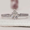 Pear shaped diamond engagement ring with V prong setting.
