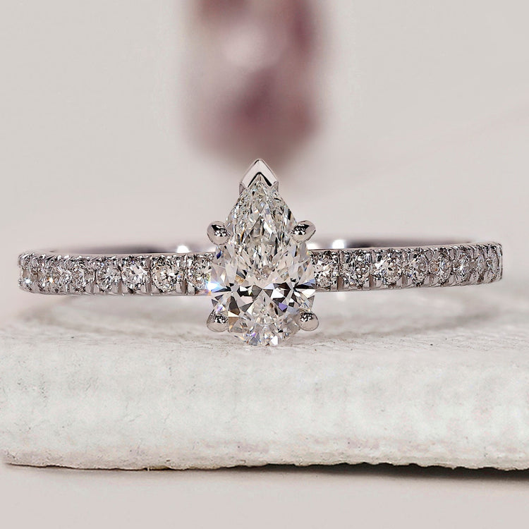 Pear shaped diamond engagement ring with V prong setting.
