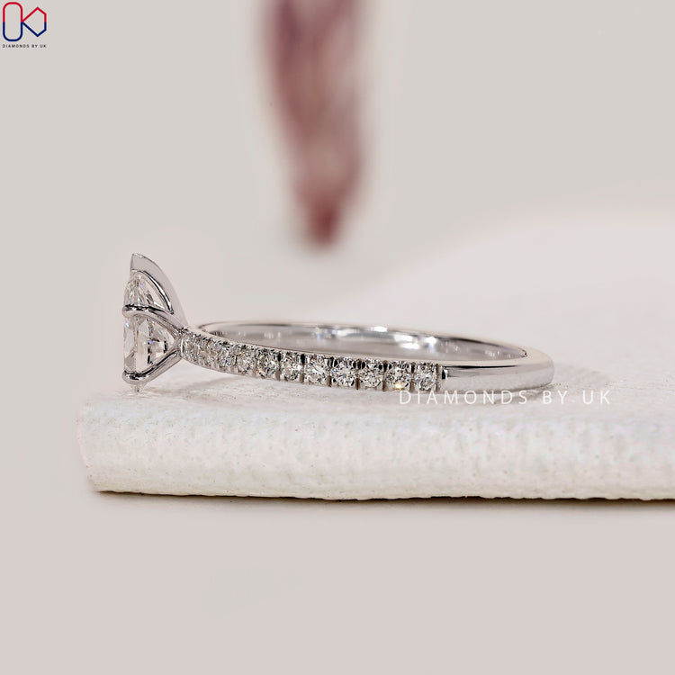 White gold ring with pear shaped diamond center.
