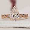 Pear shape engagement ring with marquise outline.
