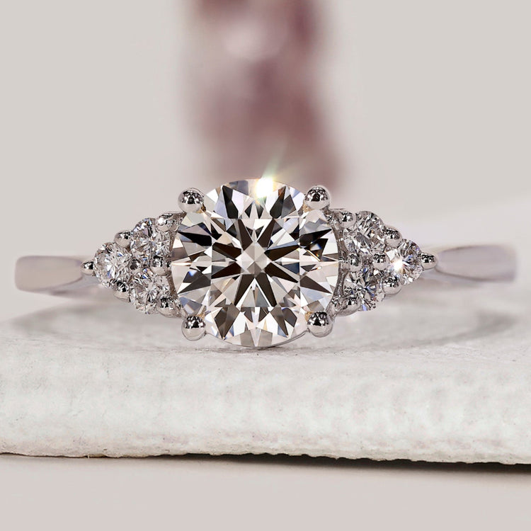 Round diamond engagement ring with muse set ring.
