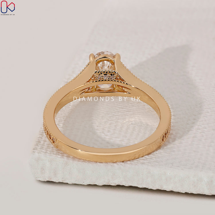 Yellow gold engagement ring with vintage-inspired design.
