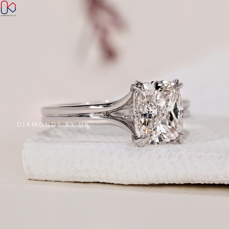Handmade ring featuring a cushion cut diamond and heart shaped prongs.