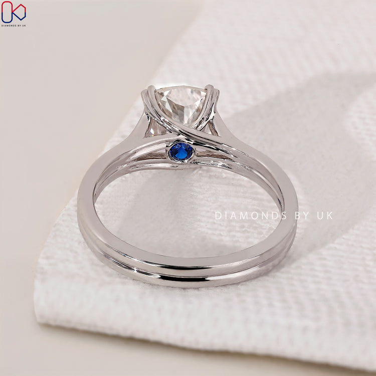 Blue diamond ring with a cushion cut diamond centrepiece.
