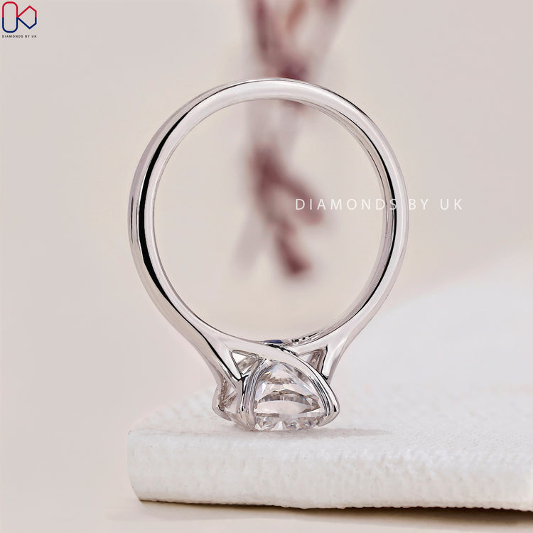 White gold ring featuring a heart shaped prongs design.