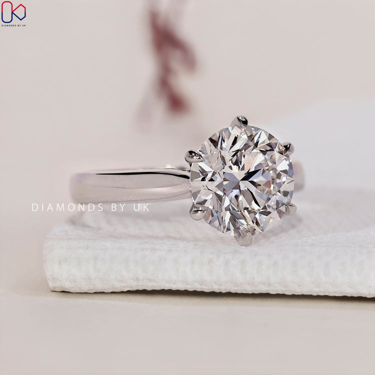 Solitaire setting ring featuring a stunning round diamond engagement ring.