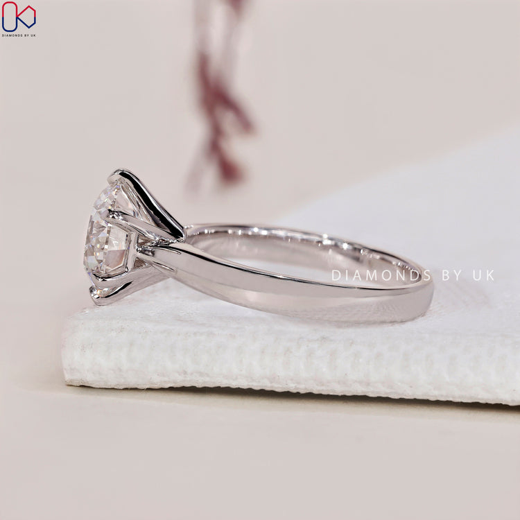 White gold ring set with a round diamond engagement ring in a solitaire setting.