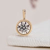 Diamond solitaire pendant with a round diamond design.
