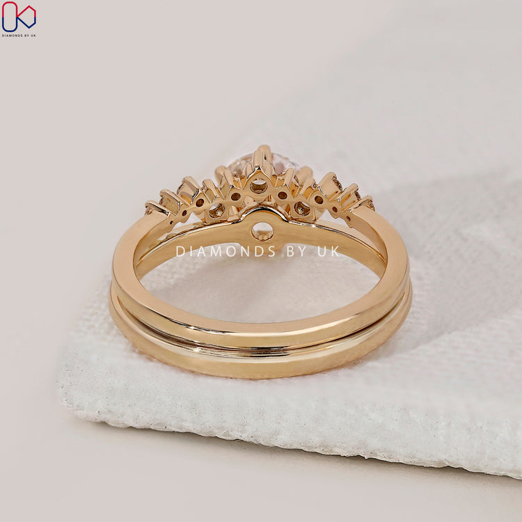 Yellow gold bridal set with solitaire ring and round diamond wedding band.
