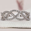 Wave wedding band paired with round cut diamond band design.
