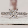 Princess diamond ring with round diamond pave set.

